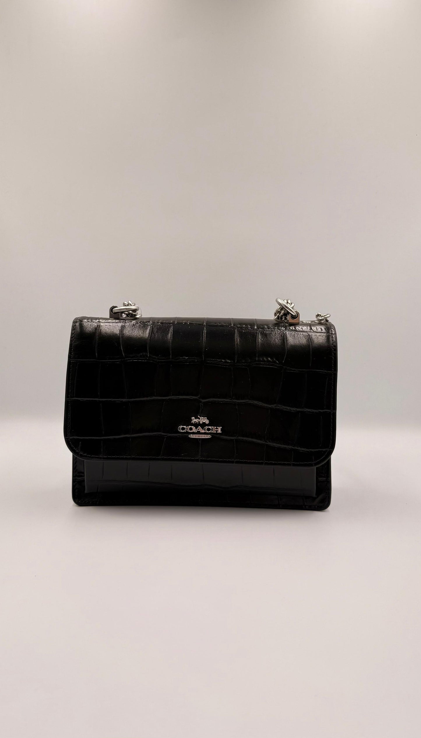 Coach Klare Crossbody en negro con textura de cocodrilo.